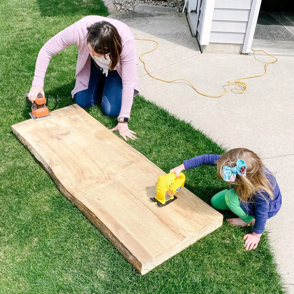 Daughter help sanding raw edge pur table top